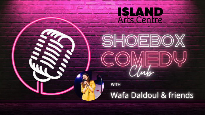 Promotional banner for the ISLAND Art’s Shoebox Comedy Club featuring a neon microphone icon and headshot of Wafa Daldoul against a pink brick wall.
