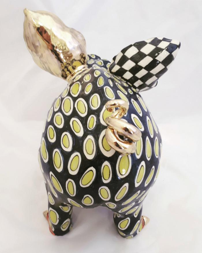 Rear view of a black and white ceramic, glazed pig by artist Ann-Marie Robinson